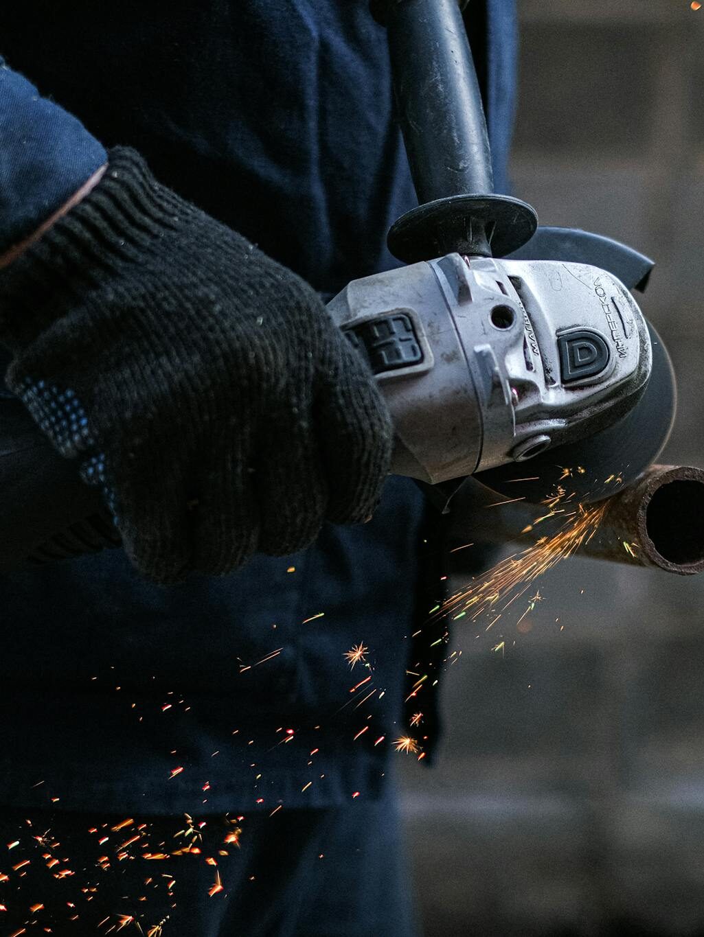 A Person Using a Black Corded Power Tool